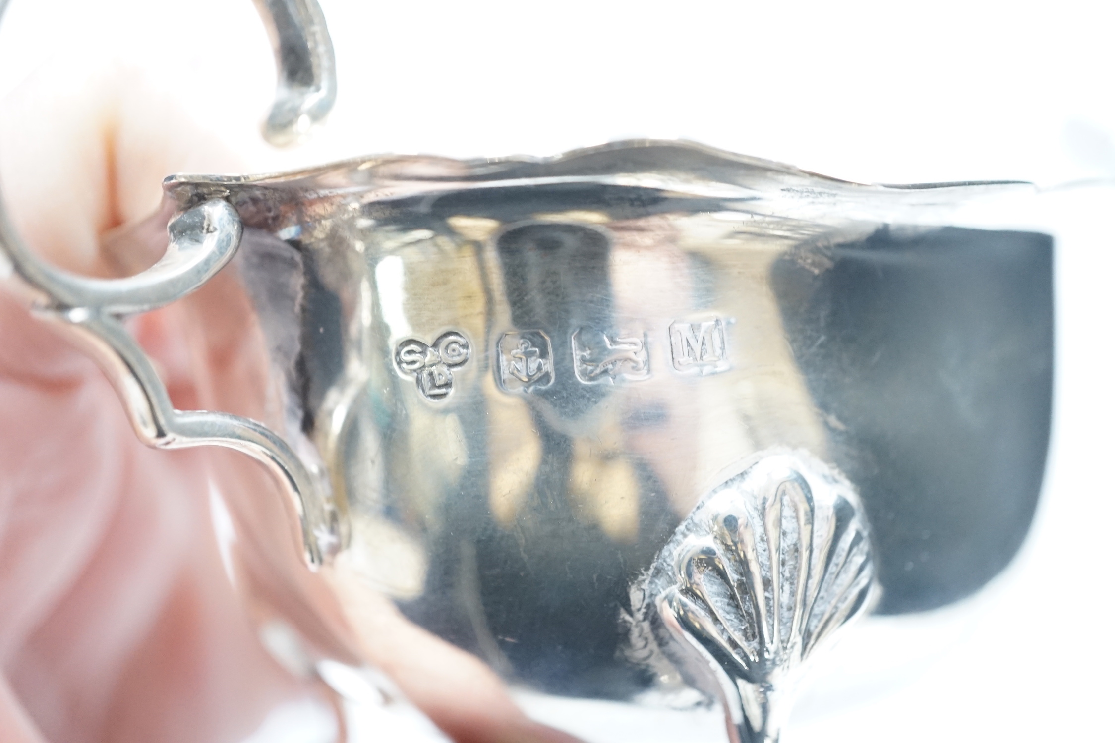 Two mid 20th century silver sauce boats and a similar silver sauce ladle, 8.1oz.
